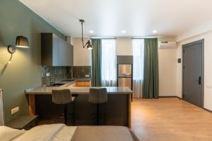 a kitchen with a sink and a counter in a room at Stones Throw Apartments in Tbilisi City