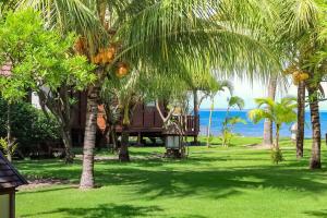 a resort with palm trees and the ocean in the background at Mina Tanjung Hotel in Tanjung