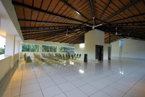 a room with chairs and tables in a building at J S Grand in Yelagiri