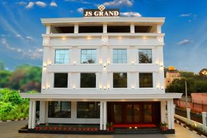a white building with a sign on top of it at J S Grand in Yelagiri