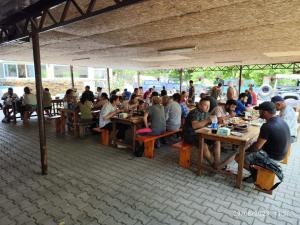 a group of people sitting at tables in a restaurant at Caner Mountain Hotel in Antalya