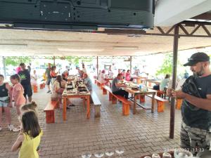 a group of people sitting at tables in a restaurant at Caner Mountain Hotel in Antalya +8 photos