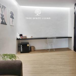 a white room with a desk and a chair at Tree Space Living in Ban Don Ta Koet