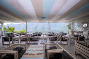 a restaurant with tables and chairs and a large window at Beach Lodge in Pokhara