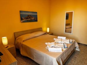 a bedroom with a bed with towels on it at MF House in Taormina