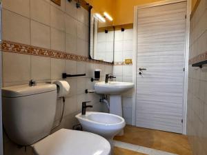 a bathroom with a toilet and a sink at MF House in Taormina +25 photos