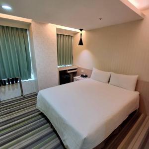 Ένα ή περισσότερα κρεβάτια σε δωμάτιο στο Morwing Hotel Fuzhong