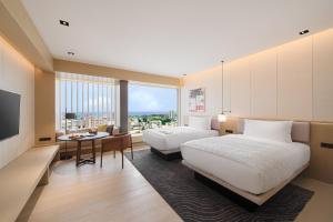 a hotel room with two beds and a table at Le Meridien Hualien Resort in Hualien City