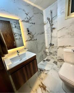 a white bathroom with a sink and a shower at Maison du sud hotel in Ibil es-saqi +45 photos