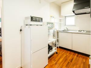 a kitchen with a white refrigerator and a microwave at Matsufuji 4F 401 or 402 in Naha +36 photos