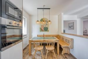 a kitchen with a wooden table and chairs and a dining room at Ivana in Karpijan in Umag