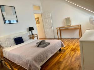 a bedroom with a bed with a blanket on it at Isle of Wight Seaview in Shanklin