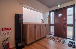 a room with a large window and a wooden door at 5分車程札幌中心大通公園 豐平川河景四房 廁所x2 浴室x1 淋浴x1 包棟別墅近地鐵 停兩台車 in Sapporo