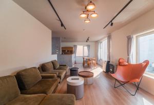 a living room with a couch and a tv at 5分車程札幌中心大通公園 豐平川河景四房 廁所x2 浴室x1 淋浴x1 包棟別墅近地鐵 停兩台車 in Sapporo
