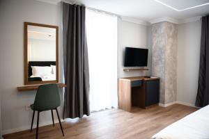 TV a/nebo společenská místnost v ubytování Hotel Luciano