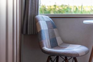 a chair sitting in front of a window at 5分車程札幌中心大通公園 豐平川河景四房 廁所x2 浴室x1 淋浴x1 包棟別墅近地鐵 停兩台車 in Sapporo