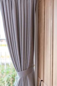 a curtain that is taped to a window at 5分車程札幌中心大通公園 豐平川河景四房 廁所x2 浴室x1 淋浴x1 包棟別墅近地鐵 停兩台車 in Sapporo