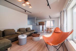 a living room with a couch and a chair at 5分車程札幌中心大通公園 豐平川河景四房 廁所x2 浴室x1 淋浴x1 包棟別墅近地鐵 停兩台車 in Sapporo