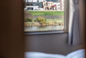 a view of a river from a window at 5分車程札幌中心大通公園 豐平川河景四房 廁所x2 浴室x1 淋浴x1 包棟別墅近地鐵 停兩台車 in Sapporo