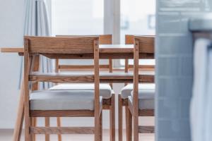 a dining room table with wooden chairs at 5分車程札幌中心大通公園 豐平川河景四房 廁所x2 浴室x1 淋浴x1 包棟別墅近地鐵 停兩台車 in Sapporo