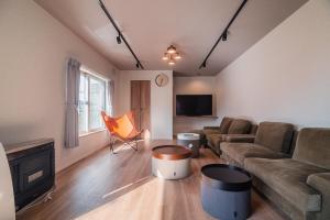 a living room with a couch and a fireplace at 5分車程札幌中心大通公園 豐平川河景四房 廁所x2 浴室x1 淋浴x1 包棟別墅近地鐵 停兩台車 in Sapporo