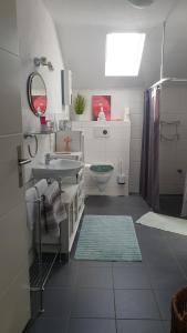 a white bathroom with a sink and a toilet at Casa Mosella in Riol