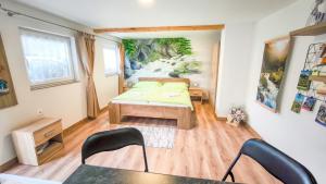 a room with a bed and a table and chairs at Apartmán Veronika in Spišský Štvrtok