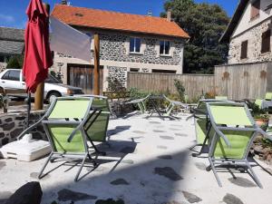 a group of chairs and tables on a patio at la chaumière des barthes in Laussonne