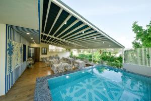 a house with a swimming pool and a patio at Dera Jaipur - Luxury Heritage Stays in Bani Park, Jaipur in Jaipur