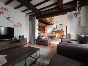 a living room with a couch and a tv at La Croix Bala in Signy-le-Petit