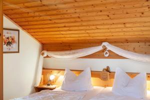 a bedroom with a bed with a wooden ceiling at Ferienhaus St Christoph in Mittenwald