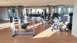 a gym with a lot of equipment in a room at comfy Primeworld district in Lapu Lapu City