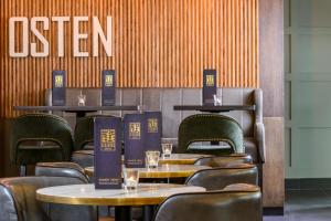 a restaurant with tables and chairs and a sign on the wall at Glashaus Hotel in Tallaght