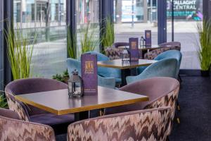 a row of tables and chairs in a restaurant at Glashaus Hotel in Tallaght