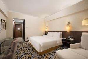 Ένα ή περισσότερα κρεβάτια σε δωμάτιο στο Grand Noble Hotel Xi’an