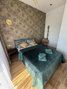a bedroom with a bed with a green comforter at Resort Hevenia Mrzeżyno - Apartament 3 in Mrzeżyno