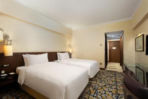 Ένα ή περισσότερα κρεβάτια σε δωμάτιο στο Grand Noble Hotel Xi’an