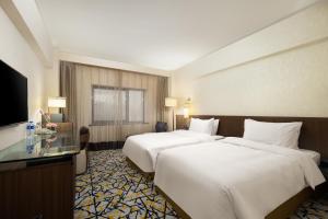 Ένα ή περισσότερα κρεβάτια σε δωμάτιο στο Grand Noble Hotel Xi’an