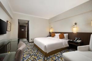 Ένα ή περισσότερα κρεβάτια σε δωμάτιο στο Grand Noble Hotel Xi’an
