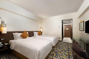 Ένα ή περισσότερα κρεβάτια σε δωμάτιο στο Grand Noble Hotel Xi’an