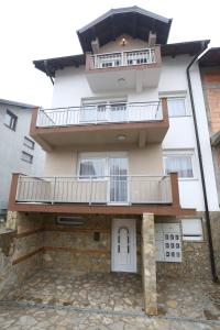 a building with a balcony on top of it at Apartments Kolonija in Sarajevo