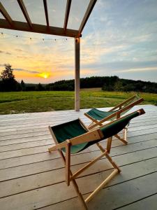 a chair on a deck with the sunset in the background at Chatka ChoćCo in Ryglice +19 photos