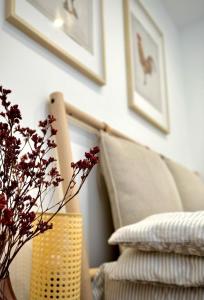 a living room with a chair and a vase with flowers at Chatka ChoćCo in Ryglice
