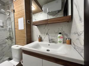 a bathroom with a sink and a toilet at Old Town Apartment 3 with Free Private Parking in Plovdiv +14 photos