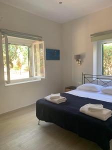 Postel nebo postele na pokoji v ubytování Aeacus Serenity Apartment