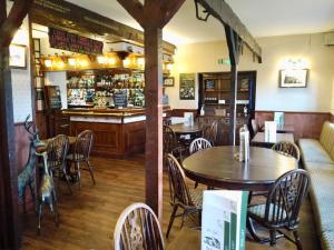 a restaurant with tables and chairs and a bar at Room with Newly Renovated Private Bathroom above Village Pub Stag Inn Crosby Maryport in Maryport