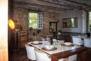 a dining room with a table and chairs at Elégance Périgourdine and SPA in Sainte-Sabine