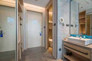 a bathroom with a sink and a mirror at Holiday Inn Express Shenzhen Nanshan by IHG in Shenzhen +62 photos