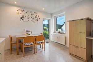 a kitchen and dining room with a table and chairs at Schöner Ith Blick in Salzhemmendorf