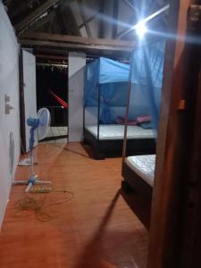 a room with a bed with a fan and a spotlight at Amfriwen Homestay in Yennanas Besir